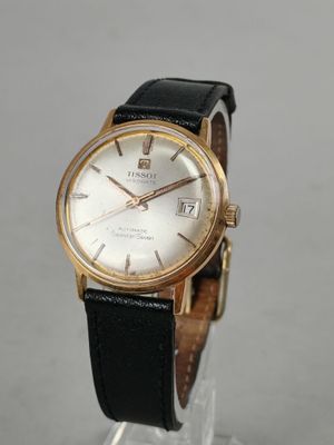 a close up of a wrist watch on a clear display stand