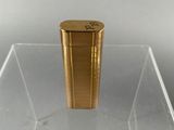 an image of a gold lighter sitting on top of a clear box