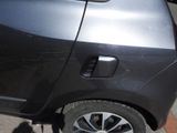 a car that has a broken door handle on the side of the road
