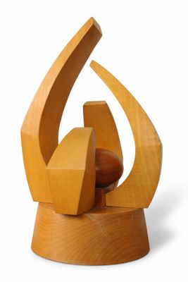 wooden sculpture of a stylized shape on a wooden base