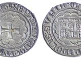 a close up of two silver coins with a cross on them