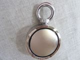 a picture of a pocket watch on a white cloth