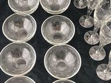 a lot of empty wine glasses and plates on the table