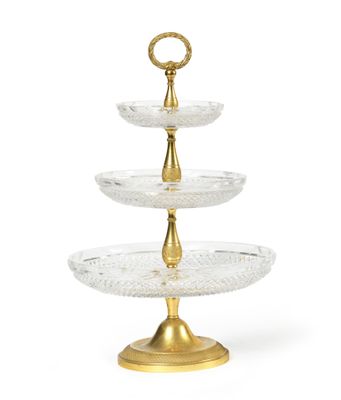 a three tiered glass cake stand with gold accents