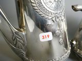 a silver tea pot and a silver tea pot on a table