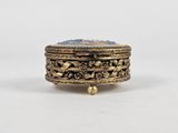 a close up of a gold ring with a blue stone in it
