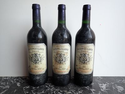 three bottles of wine that are sitting on a table