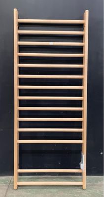 a wooden rack that is leaning against a black wall