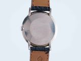 a close up of a watch on a white surface with a white background