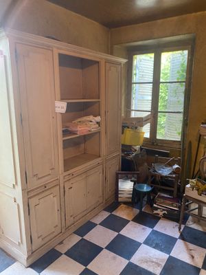 a room that has a checkered floor and a cabinet in it