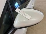 a sticker on the side mirror of a white car