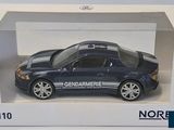a blue toy car in a white box on a table