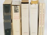 plusieurs livres sont alignés sur une surface blanche