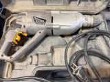 a drill in a case that is sitting on a table