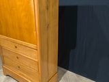 an image of a tall wooden cabinet with drawers