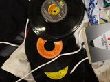 a black record sitting on top of a pile of clothes