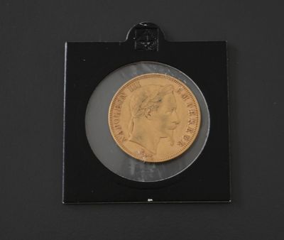 a close up of a gold coin in a black frame