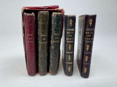 plusieurs vieux livres posés les uns sur les autres sur une surface blanche