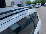 many cars parked in a parking lot next to each other