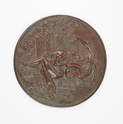 a bronze plaque with a woman and a dog on it