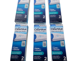 Quatre brosses à dents Clearblue sont alignées sur une surface blanche
