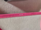 a close up of a purse with a pink handle