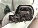 the side view mirror of a car with the door handle missing