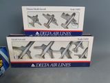 two boxes of delta airlines airplane cutters next to a can of soda