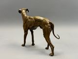 bronze statue of a greyhound dog on a white background