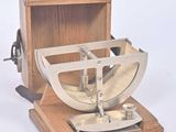 a wooden box with a metal object inside of it