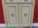 an image of a white cabinet with two doors and a drawer on top