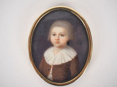 portrait of a young boy in a brown jacket and white collared shirt
