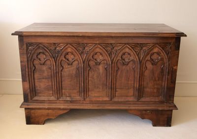 an old wooden chest sitting on top of a carpeted floor