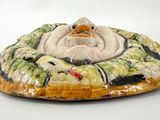 a ceramic figurine of a dog on a plate