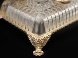 a gold plate with a glass cover on it