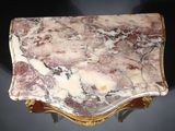 an image of a marble top table with gold trimming