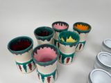 many cups that are sitting on the table together