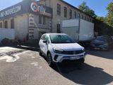 a white car parked in front of a building