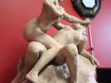 a statue of a man and a woman on a rock