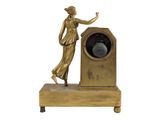 a statue of a woman standing next to a clock
