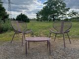 two chairs and a table on the gravel road