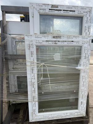 a pile of old windows sitting on top of a pallet
