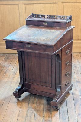 a wooden desk with a marble top on a hard wood floor