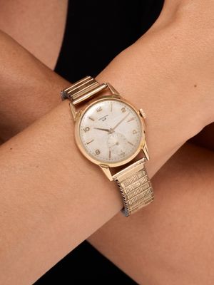 a close up of a woman ' s wrist with a watch on it