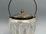 a silver and glass ice bucket with a handle and handle