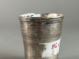 a silver cup that has a sticker on the side of it
