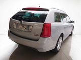 a silver car that is parked in a white room