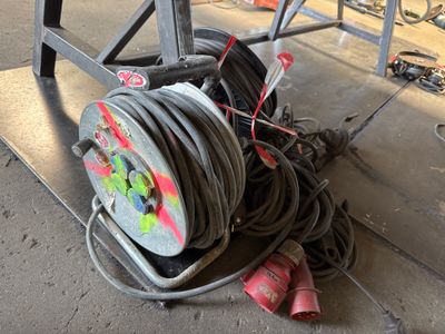 a hose that is sitting on the ground next to some wires