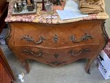 a chest of drawers with a clock on top of it