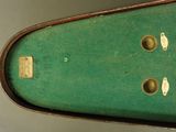 a green case with holes in it on the wall
